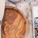 Olive wood plate on a marbled table set up