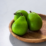 Round olive wood plate handcrafted in Tunisia with three green pears 