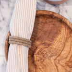 Halfa Napkin Ring around a napkin in Dora Wooden plate