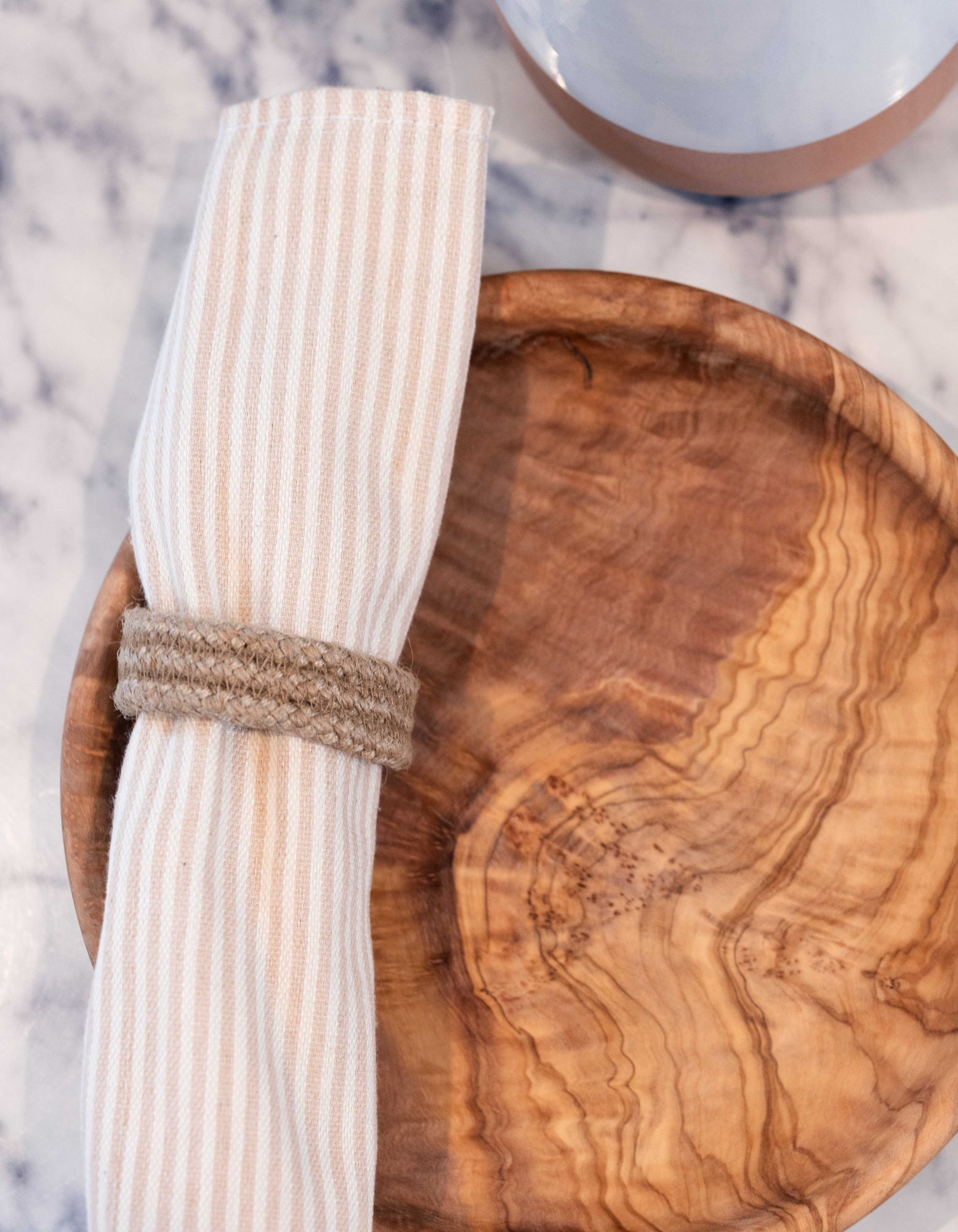 Halfa Napkin Ring around a napkin in Dora Wooden plate