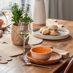 Table set up with ceramic, olive wood, halfa fiber dinnerware made in Tunisia