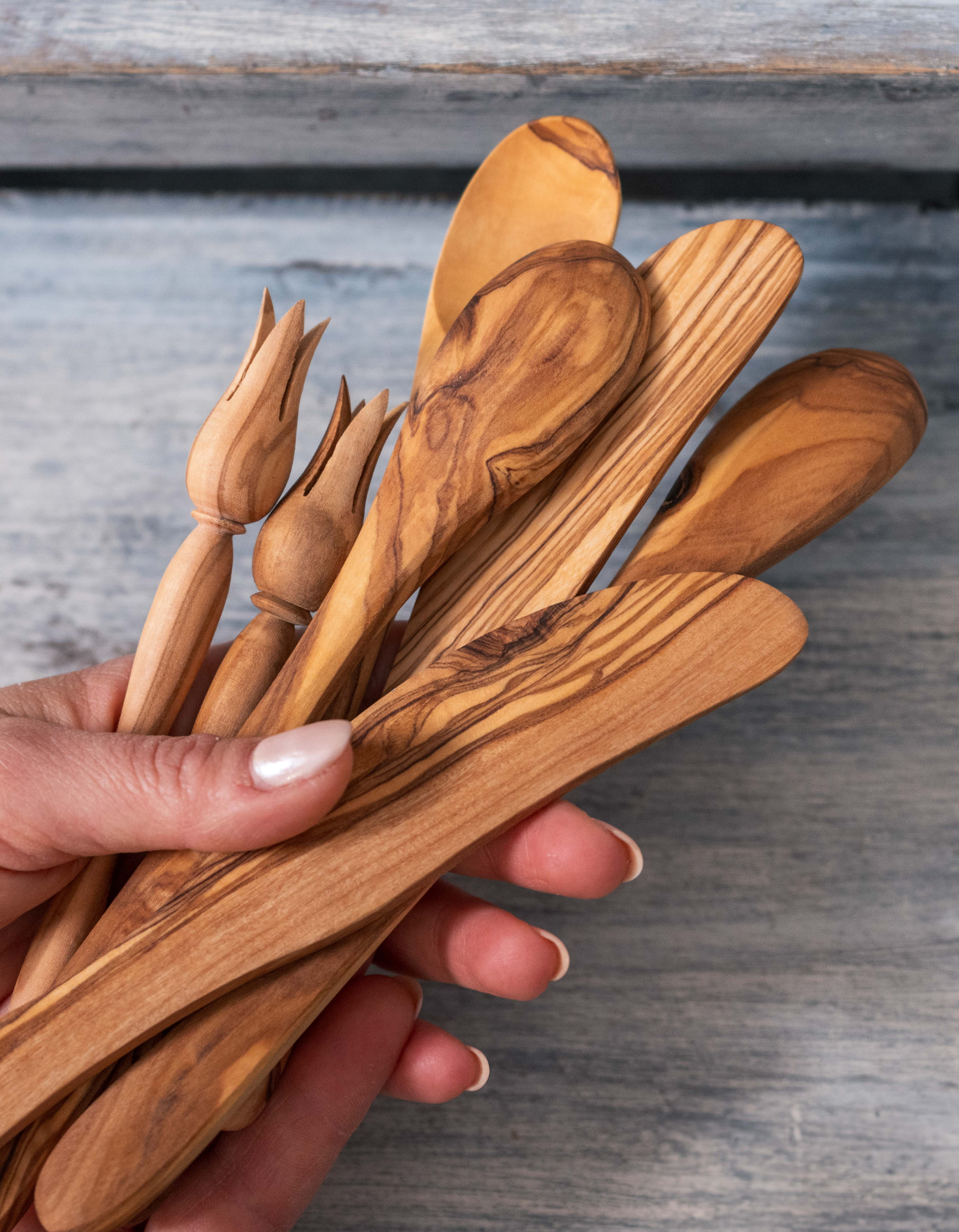 A hand full of olive wood utensils, handmade in Tunisia