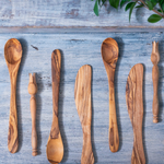 Assortment of aligned olive wood utensils, made in Tunisia