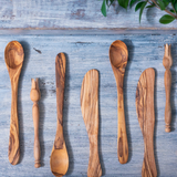 Assortment of aligned olive wood utensils, made in Tunisia