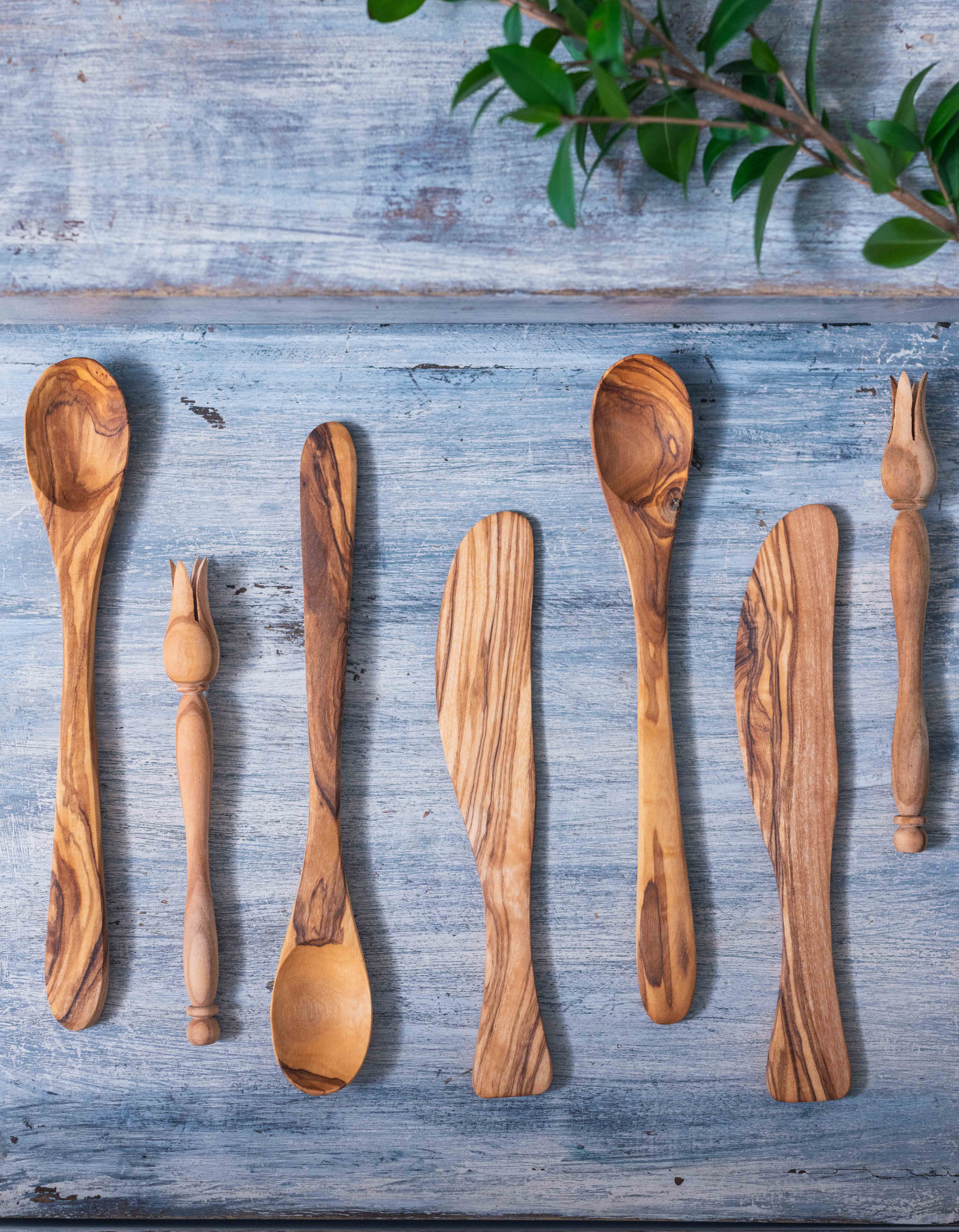 Assortment of aligned olive wood utensils, made in Tunisia