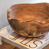 Rustic edges Wooden Bowl placed on an entryway console